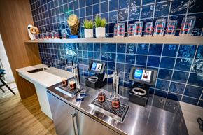 Henderson apartment for rent - a kitchen with a counter with coffee machines and a tv