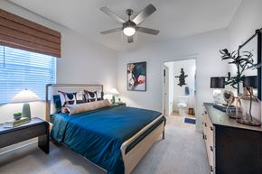 Henderson apartment for rent - a bedroom with a bed and a ceiling fan