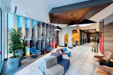 Falls Church apartment for rent - A modern living room with a large sectional sofa and a wooden ceiling.