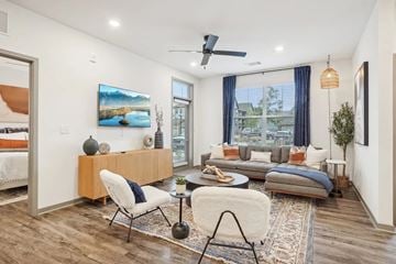 Longmont apartment for rent - A modern living room with a white sofa, a wooden side table, and a painting on the wall.