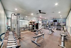 San Antonio apartment for rent - a gym with a lot of exercise equipment and a ceiling fan