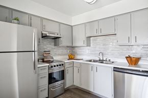 El Paso apartment for rent - a white kitchen with stainless steel appliances and white cabinets