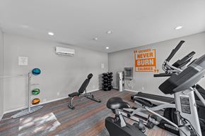 Dallas apartment for rent - A gym room with a row of exercise bikes and a sign that says