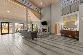 Dallas apartment for rent - A modern living room with a fireplace and a television.