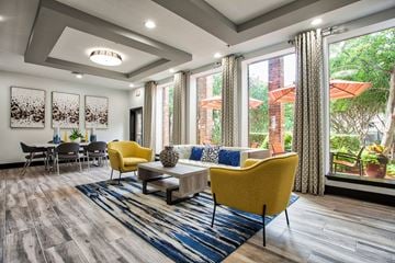 Mesquite apartment for rent - A living room with a yellow chair and a blue rug.