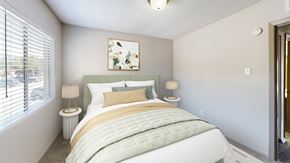 Dallas apartment for rent - A bedroom with a large bed and a painting on the wall.