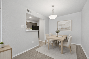 Dallas apartment for rent - A dining room with a wooden table and chairs.