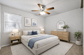 Dallas apartment for rent - A bedroom with a bed, nightstands, and a plant.