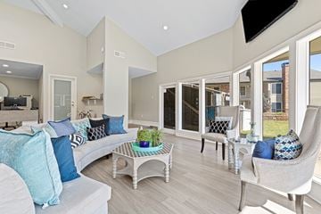 Arlington apartment for rent - A living room with a white couch and a glass table.