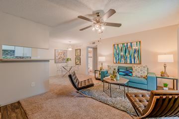 Bedford apartment for rent - A living room with a blue couch and a ceiling fan.