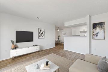 North Richland Hills apartment for rent - the living room and kitchen of an apartment with a tv