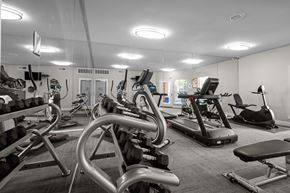 Dallas apartment for rent - A gym with a variety of exercise equipment including treadmills, stationary bikes, and weight machines. at Preston Bend, Dallas