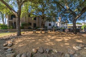 Frisco apartment for rent - a picnic area with trees and rocks in front of a building