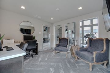 Dallas apartment for rent - a living room with two chairs and a desk and a tv