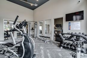 Dallas apartment for rent - a gym with exercise equipment and a tv