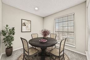 Plano apartment for rent - a dining room with a table and chairs and a window at Legacy Apartments in Plano, TX
