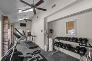 Dallas apartment for rent - A gym with a treadmill, elliptical machines, and dumbbells.