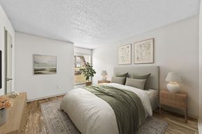 Dallas apartment for rent - a bedroom with white walls and a green bedspread  at Vesper, Dallas, TX