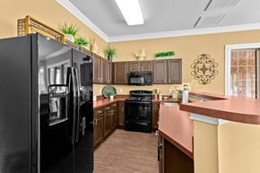 Weatherford apartment for rent - a kitchen with black appliances and a counter top at Southgate Glen, Weatherford, TX, 76086