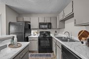 Arlington apartment for rent - A kitchen with a black refrigerator and a black oven.