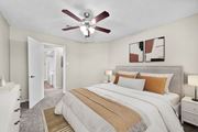 Arlington apartment for rent - A bedroom with a large bed and a ceiling fan.