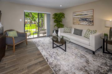 Fort Worth apartment for rent - A living room with a couch, chair, and a painting on the wall.