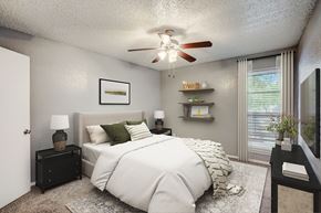 Dallas apartment for rent - our apartments offer a bedroom with a large bed and a ceiling fan