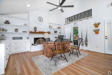 San Antonio apartment for rent - A living room with a fireplace and a dining table set up.