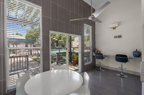 Dallas apartment for rent - a dining area with a white table and chairs and a sliding glass door that leads to a  at Vesper, Dallas