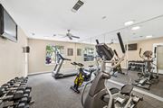 Irving apartment for rent - A gym with a variety of exercise equipment including treadmills, stationary bikes, and weight machines.