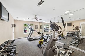 Irving apartment for rent - A gym with a variety of exercise equipment including treadmills, stationary bikes, and weight machines.