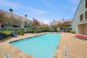 Irving apartment for rent - A swimming pool surrounded by a stone border with the number 37161 painted on it.