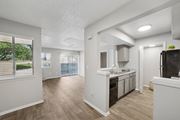 Irving apartment for rent - A kitchen with white cabinets and a black fridge.