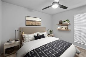 San Antonio apartment for rent - a bedroom with a ceiling fan and a window with a blind  at Carmel at Deerfield, San Antonio, Texas