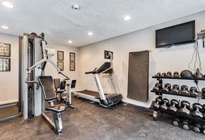San Antonio apartment for rent - the gym has plenty of exercise equipment and a tv at The Broadwater at Salado Creek, San Antonio, Texas, 78216