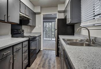 A kitchen with granite counter tops and stainless steel appliances