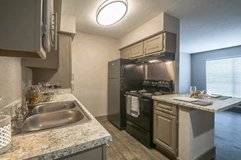 A kitchen with stainless steel appliances and granite counter tops