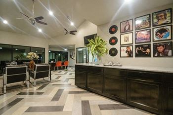A lobby with a bar and a table with chairs