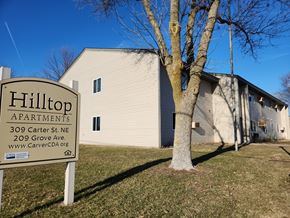 Watertown apartment for rent - Hilltop Apartments with a sign in front of a tree