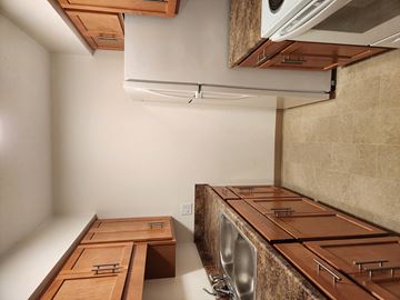 Watertown apartment for rent - a kitchen with wooden counter tops and a stainless steel sink and a dryer