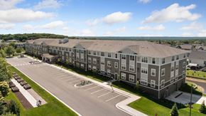 Carver apartment for rent - A large apartment complex with a parking lot in front.