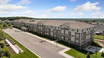 Carver apartment for rent - A large apartment complex with a parking lot in front.
