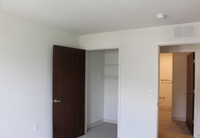 Carver apartment for rent - A white bedroom with a brown door and a white wall.