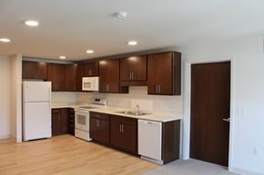 Carver apartment for rent - A kitchen with white appliances and brown cabinets.
