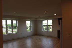Carver apartment for rent - A large empty room with wooden floors and windows.