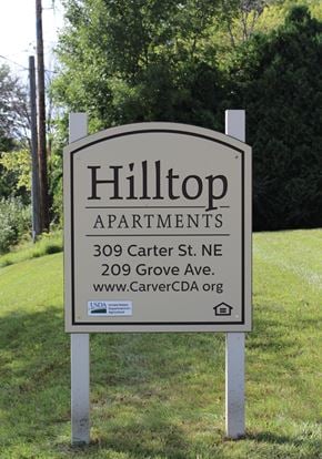Watertown apartment for rent - A sign for Hilltop Apartments is displayed in front of a green lawn.