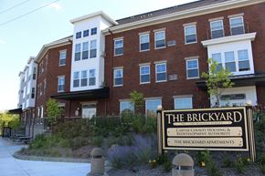 Chaska apartment for rent - Front of the Brickyard Apartments with sign.