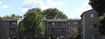 Chaska apartment for rent - Apartment buildings with balconies and trees in front.
