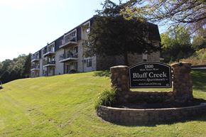 Carver apartment for rent - A sign for Bluff Creek Apartments stands in front of a building.