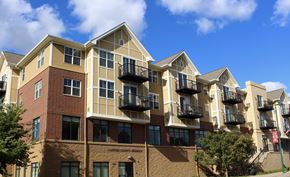 Norwood Young America apartment for rent - A large apartment building with balconies and a red brick facade.